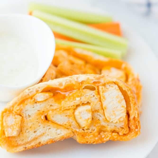 close up of buffalo chicken bread slice with celery in background