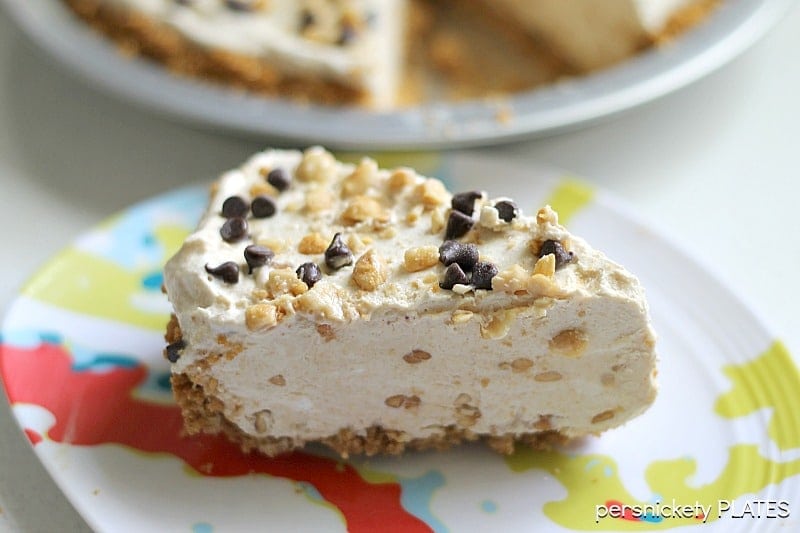 slice of no bake peanut butter pie on a colorful plate.