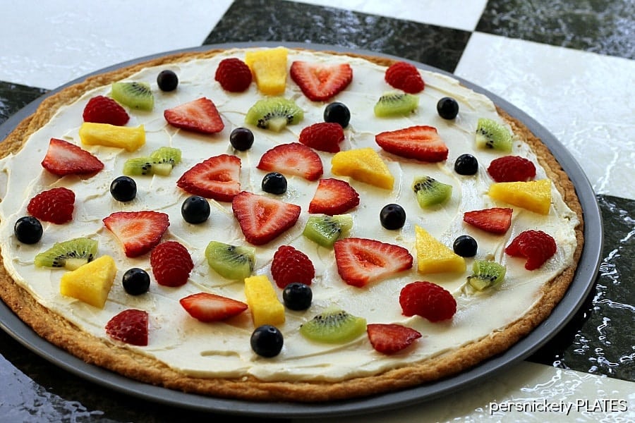 Sugar Cookie Fruit Pizza -a thin sugar cookie "crust" spread with a cream cheese "sauce" and topped with strawberries, raspberries, kiwi, blueberries, pineapple - whatever fruit you love!
