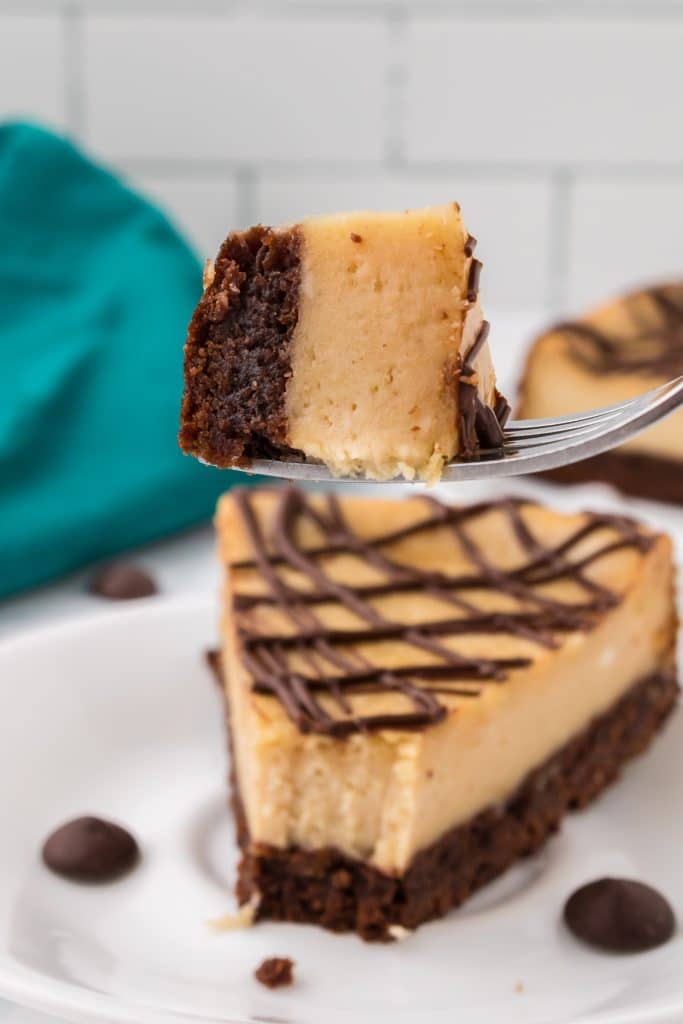 bite of peanut butter brownie cheesecake on a fork.