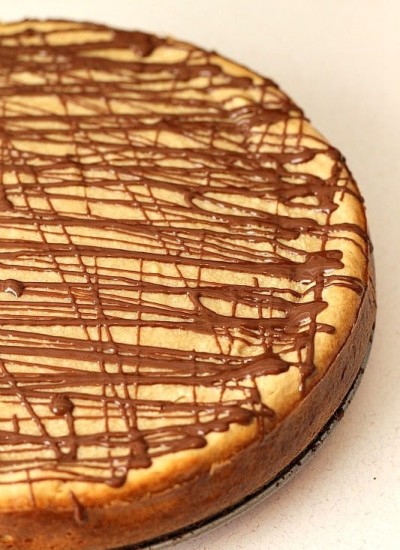 Brownie Bottom Peanut Butter Cheesecake has a layer of chewy brownie topped with a creamy peanut butter cheesecake and drizzled with rich chocolate.