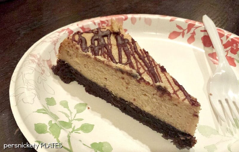 Brownie Bottom Peanut Butter Cheesecake has a layer of chewy brownie topped with a creamy peanut butter cheesecake and drizzled with rich chocolate. | www.persnicketyplates.com #cheesecake #peanutbutter #brownie #dessert