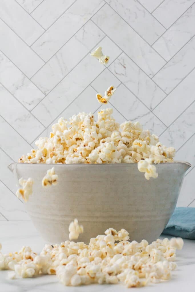 large bowl of popcorn with kernels popping.
