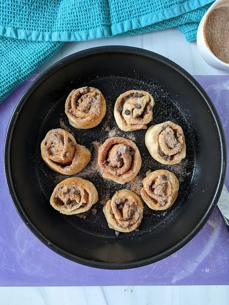 overhead shot of cinnamon rolls in a round dish before baking.