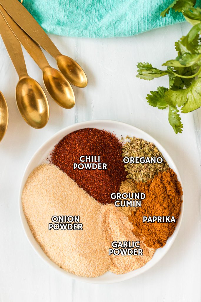 spices labeled on a white plate to make taco seasoning