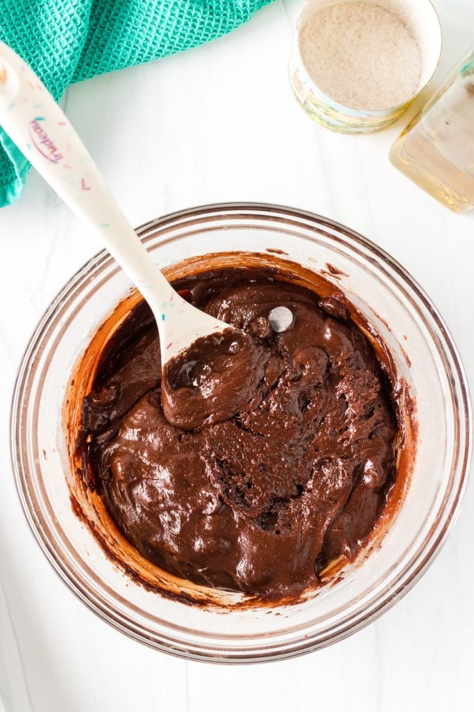 overhead shot of brownie batter in a glass mixing bowl