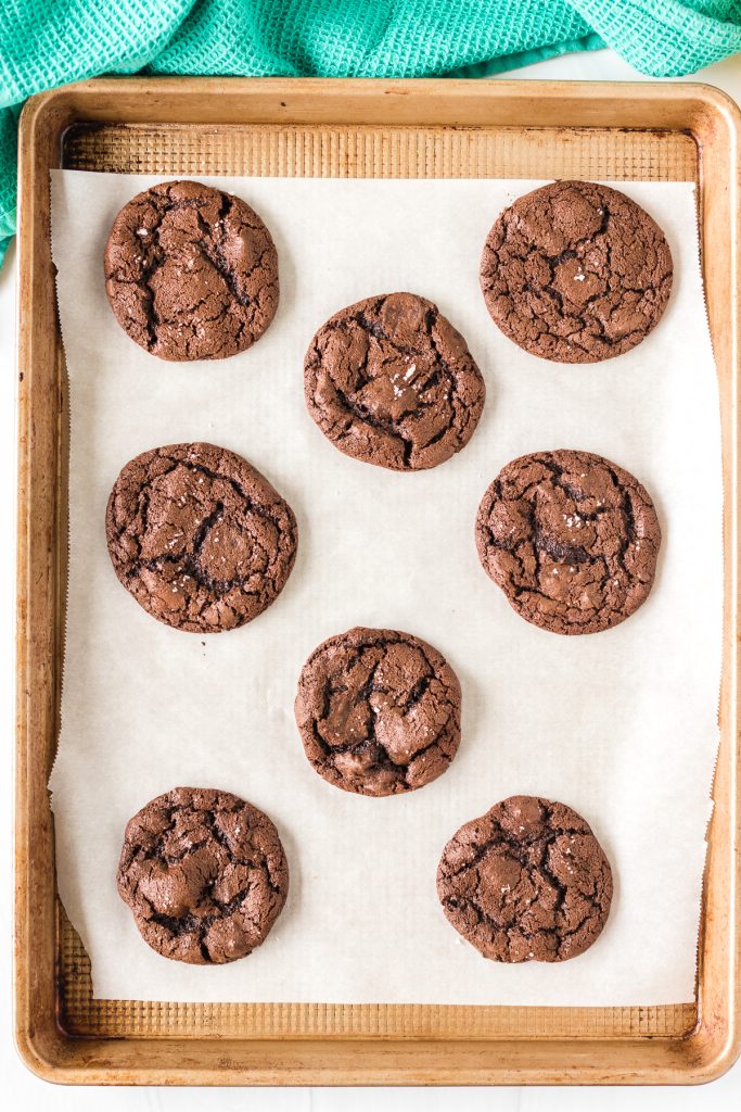 overhead shot of freshly baked brownie cookies on a baking sheet