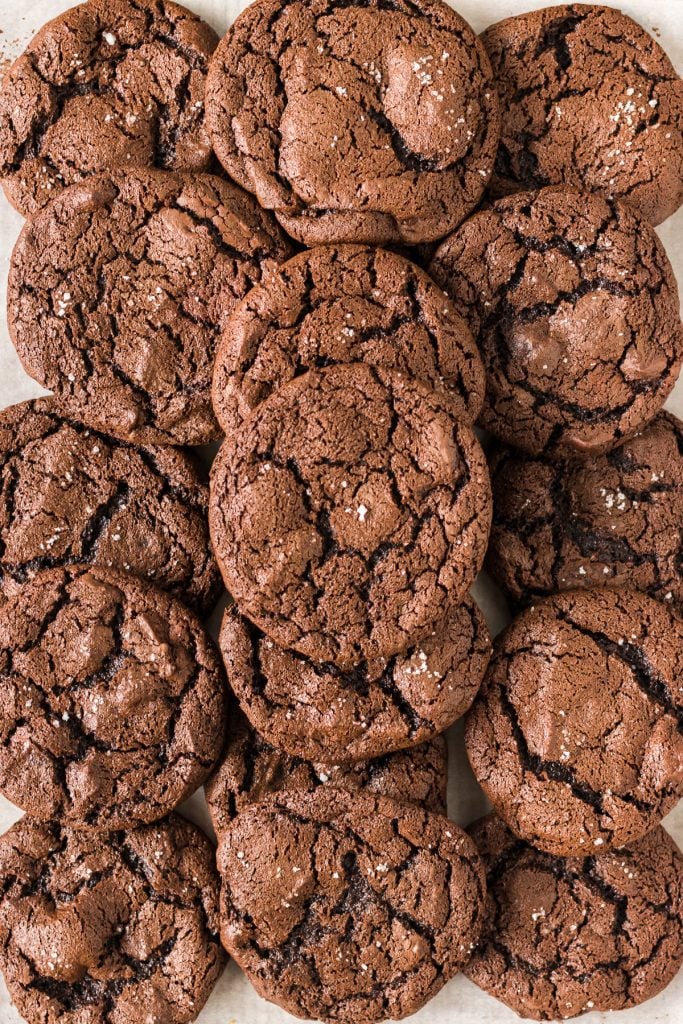 pile of chocolate brownie cookies topped with sea salt