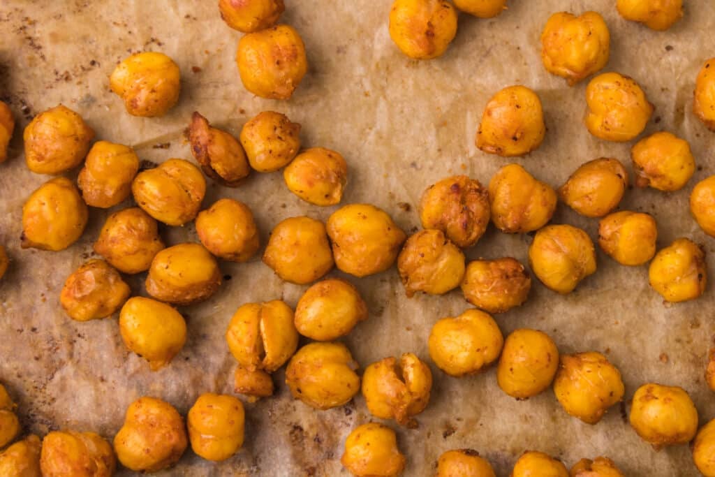 close up of roasted chickpeas on a baking sheet.