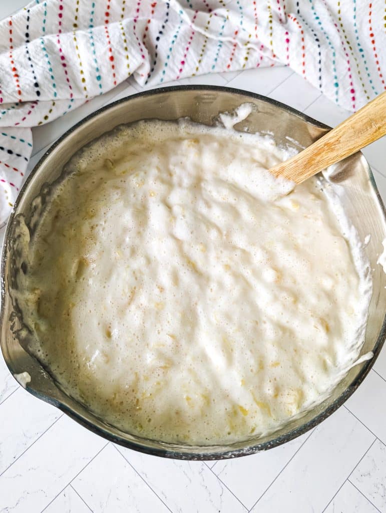 overhead shot of mixing bowl with white batter in it.