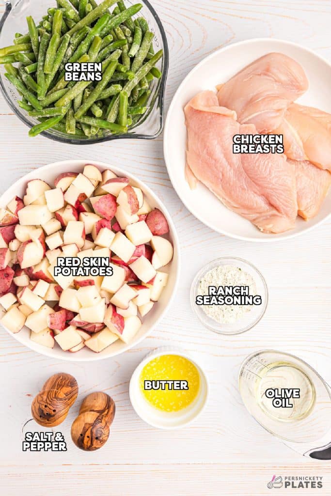 overhead shot of labeled ingredients laid out to make baked chicken and veggies.
