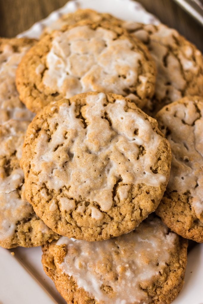 closeup of an iced oatmeal cookie in a pile