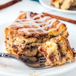 bite of cinnamon roll cheesecake on a fork.