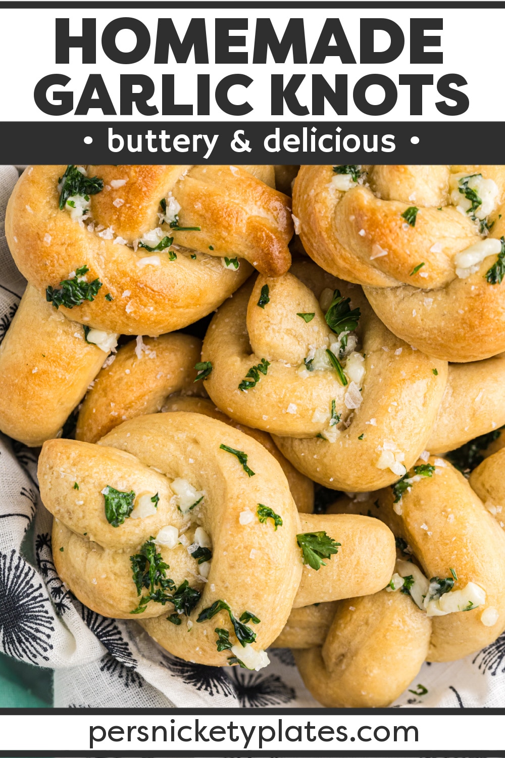 Easy Garlic Knots are homemade but simple to make. Topped with garlic butter and parmesan cheese, these buttery rolls are perfect alongside dinner or with sauce for dipping. | www.persnicketyplates.com