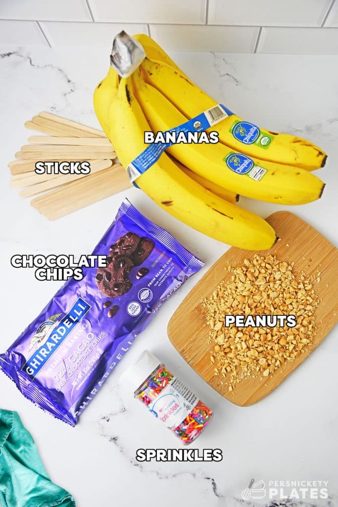 overhead shot of labeled ingredients laid out to make chocolate dipped bananas.