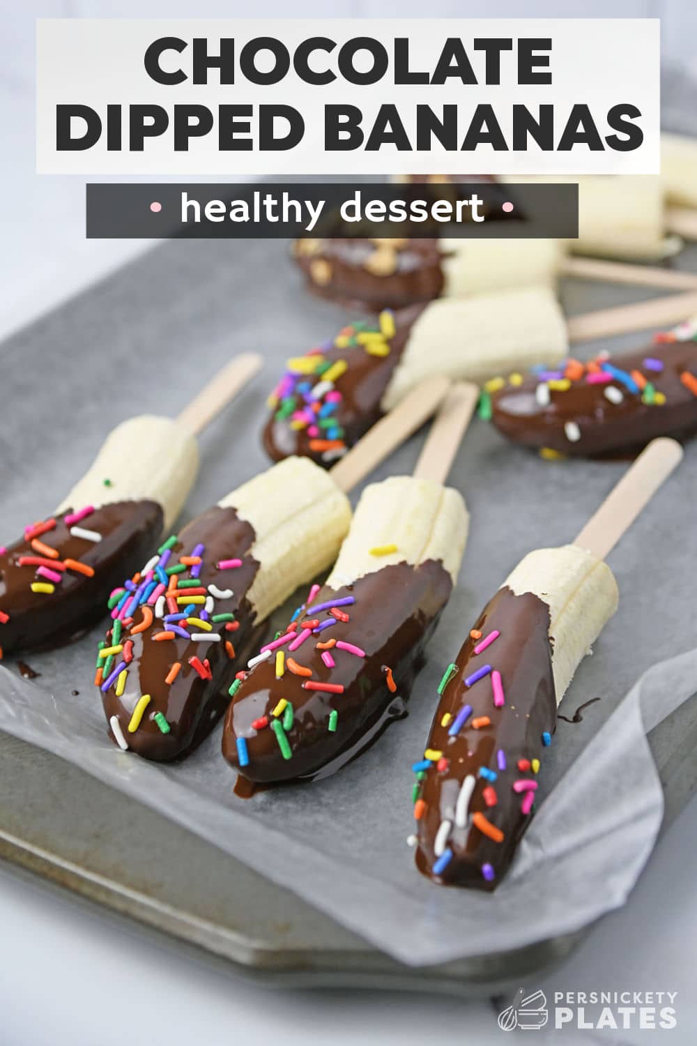 Frozen chocolate dipped bananas are as easy to make as they are to eat! Take ripe sweet bananas coat them in melted chocolate and add your favorite toppings. Allow them to freeze and set for a tasty frozen treat both kids and adults love!  | www.persnicketyplates.com