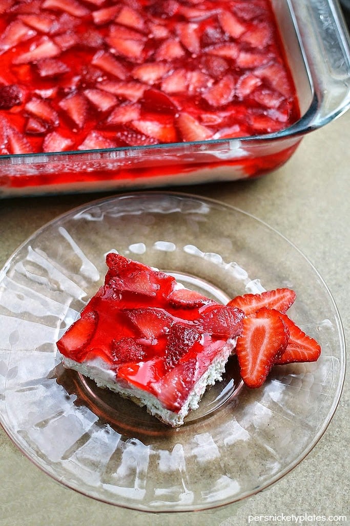 This Strawberry Pretzel Jell-O is a quick and easy summer dessert idea. Made with fresh strawberries nestled in Jell-O on top of a whipped cream layer and crunchy pretzel crust.