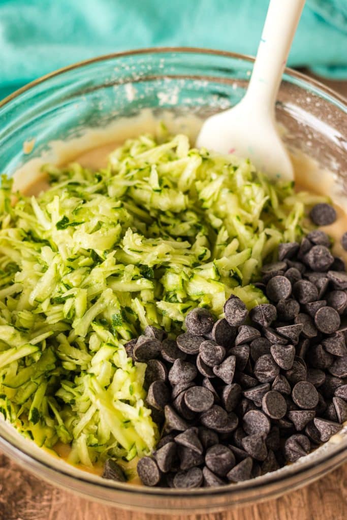 shredded zucchini and chocolate chips in a mixing bowl.