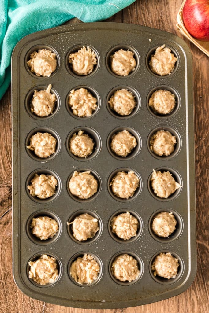 overhead shot of mini muffin pan filled with muffin batter.