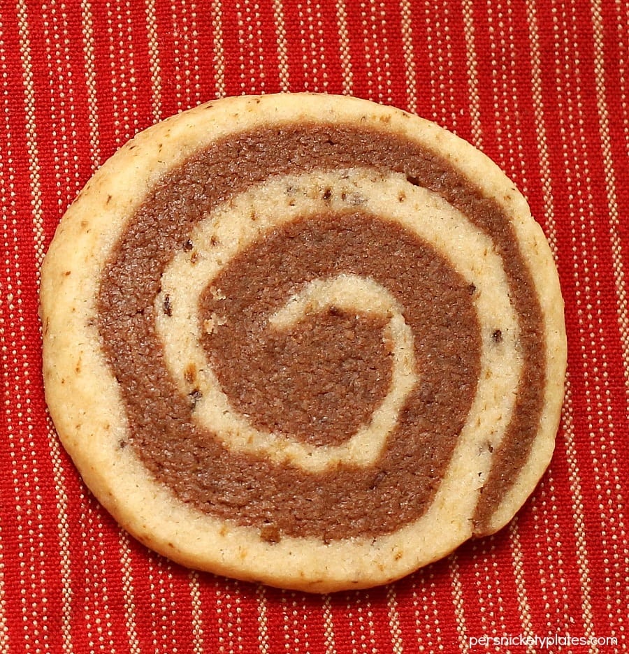 closeup of one pinwheel cookies on a red tablecloth