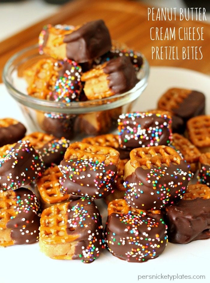 plate of peanut butter pretzel bites dipped in chocolate & topped with sprinkles