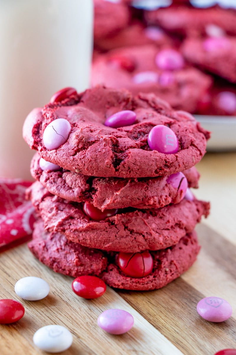 stack of 4 red velvet cake mix cookies surrounded by pink M&Ms
