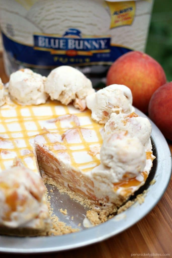 Super simple Peaches and Cream Ice Cream Pie is filled with broiled peaches, creamy vanilla bean ice cream, in a graham cracker crust and drizzled with butterscotch sauce. The perfect dessert for a hot summer day! | Persnickety Plates #SunsOutSpoonsOut #ad