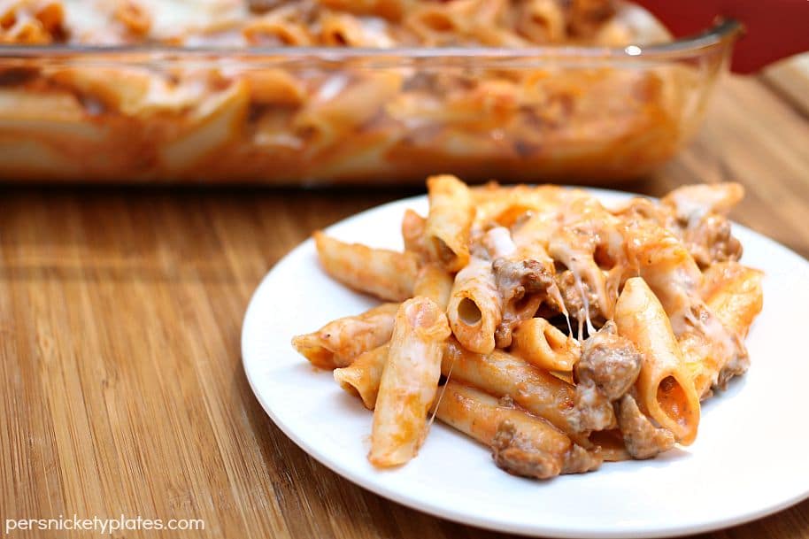 baked mostaccioli serving on a white plate 
