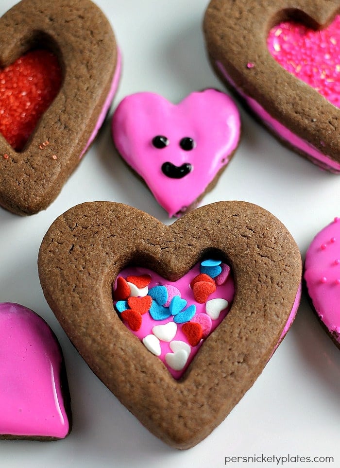 close up of chocolate heart cookie with pink frosting & sprinkles