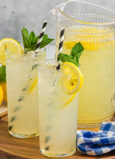glasses of old fashioned lemonade next to a pitcher.