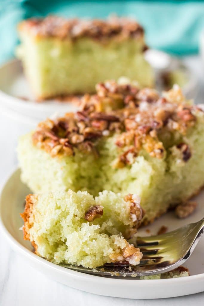 a bite of pistachio cake on a fork.