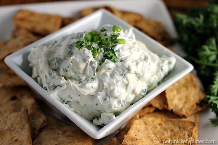 Garlic Herb Dip has a cream cheese base filled with fresh herbs. Super easy and paired with Van's Foods Crackers makes the perfect snack for your next party. | Persnickety Plates