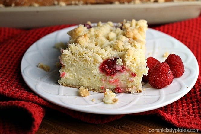 Raspberry Cream Cheese Crumb Cake is layered with a creamy cheesecake , fresh raspberries, and topped with a crunchy streusel topping. Perfect for brunch or dessert! | Persnickety Plates