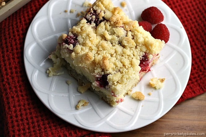 Raspberry Cream Cheese Crumb Cake is layered with a creamy cheesecake , fresh raspberries, and topped with a crunchy streusel topping. Perfect for brunch or dessert! | Persnickety Plates