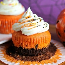 Brownie Bottom Halloween Cupcakes have a layer of dark chocolate brownie topped with orange cake batter and finished off with buttercream and sprinkles. They are the perfect mix of semi-homemade and "from scratch" to be easy but really fun and festive for your next Halloween party! | Persnickety Plates