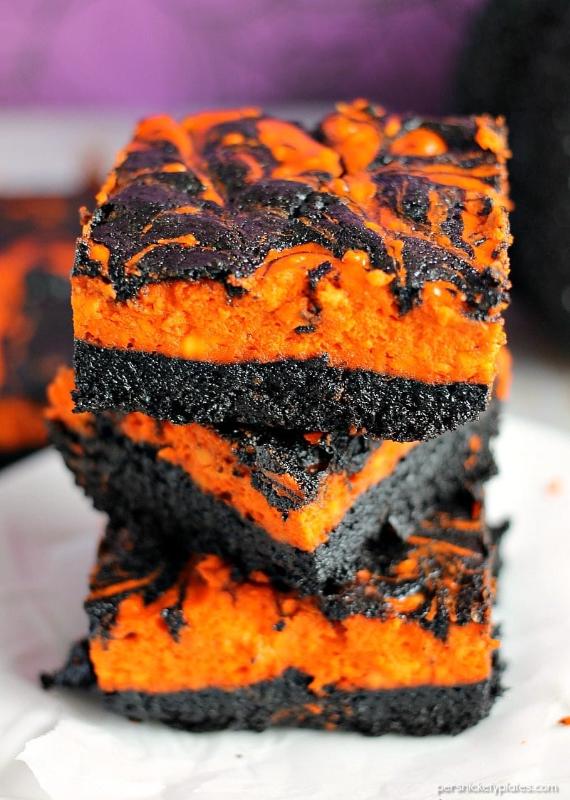 Halloween Cream Cheese Swirl Brownies have a layer of rich, dark chocolate brownie topped with a layer of orange cheesecake then swirled together for a spooky treat. | Persnickety Plates