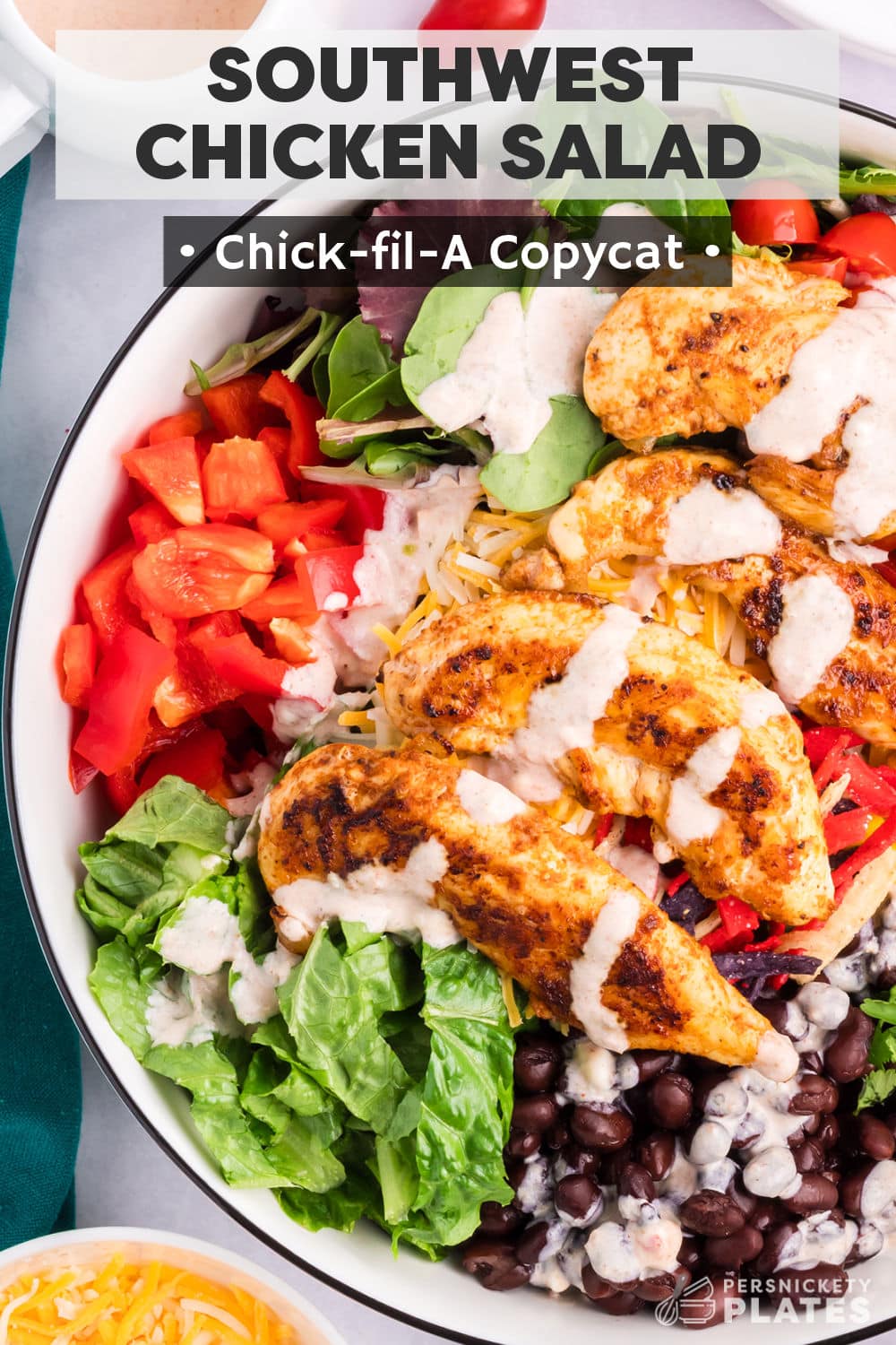 This fresh Chick-fil-A salad is a perfect copycat! Southwest chicken salad starts with spicy grilled chicken, mixed with fresh veggies, topped with a spicy-sweet salad dressing, and finished with crunchy tortilla strips. This colorful salad is loaded with southwest flavors and plenty of texture! | www.persnicketyplates.com