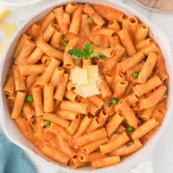 overhead shot of vodka rigatoni in a pan topped with parmesan.