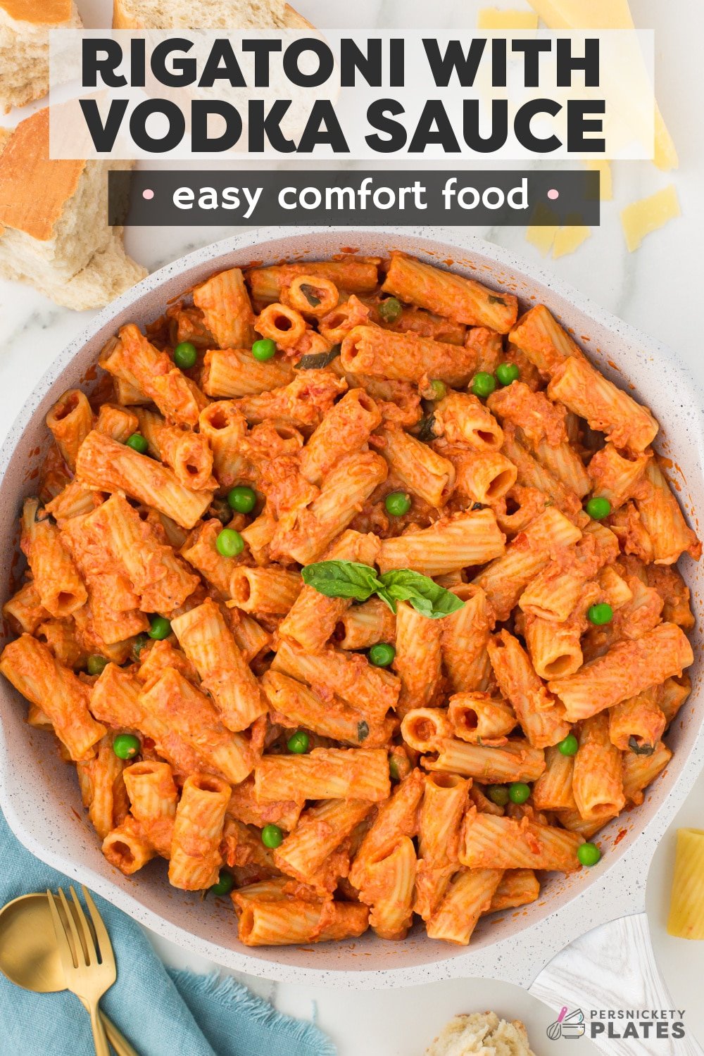 Vodka Rigatoni is a scrumptious pasta dish made with al dente pasta tossed in a rich vodka sauce made with tomatoes, heavy cream, an ounce of vodka, and parmesan cheese. Finished with fresh basil and peas, this easy and elegant one-pan meal is perfect for busy weeknights and fancier occasions!  | www.persnicketyplates.com