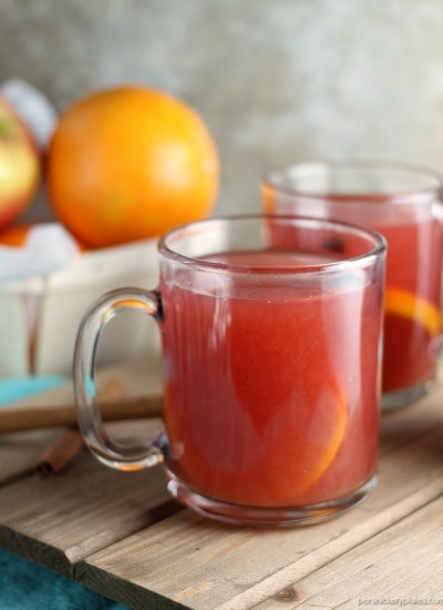 Cranberry Orange Cider only takes about 15 minutes to make and is perfect for all the winter and holiday activities that leave you cold and in need of warming up! | www.persnicketyplates.com