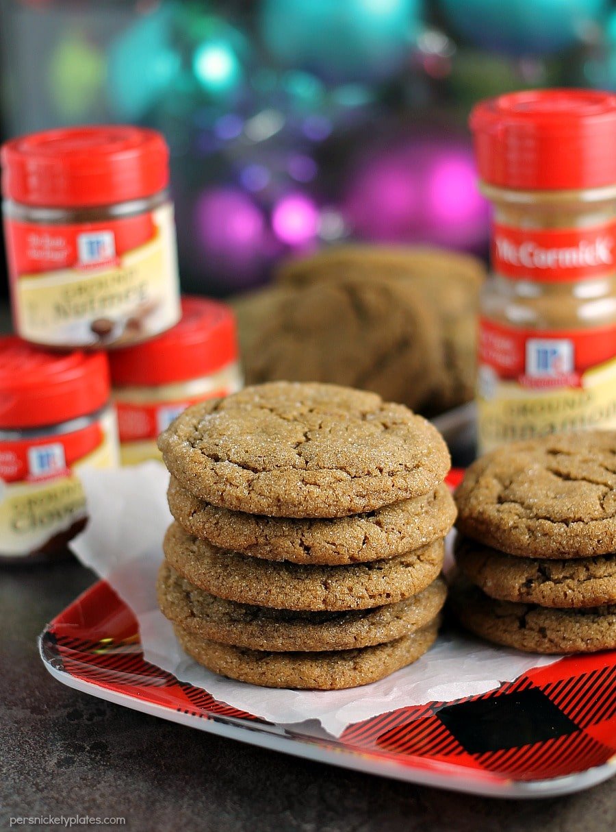 stack of ginger snap cookies with spices in background
