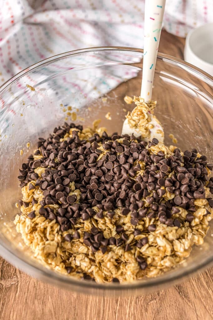 mini chocolate chips in a mixing bowl with oats.