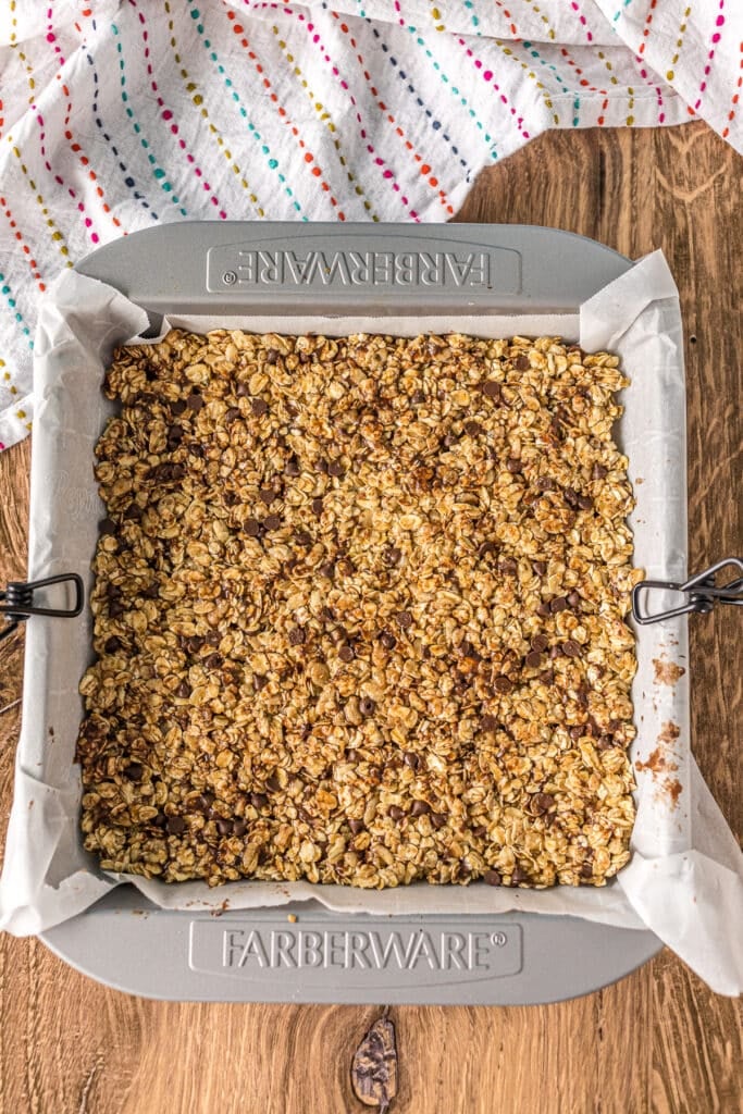 overhead shot of granola bars pressed into a 9x9 pan.