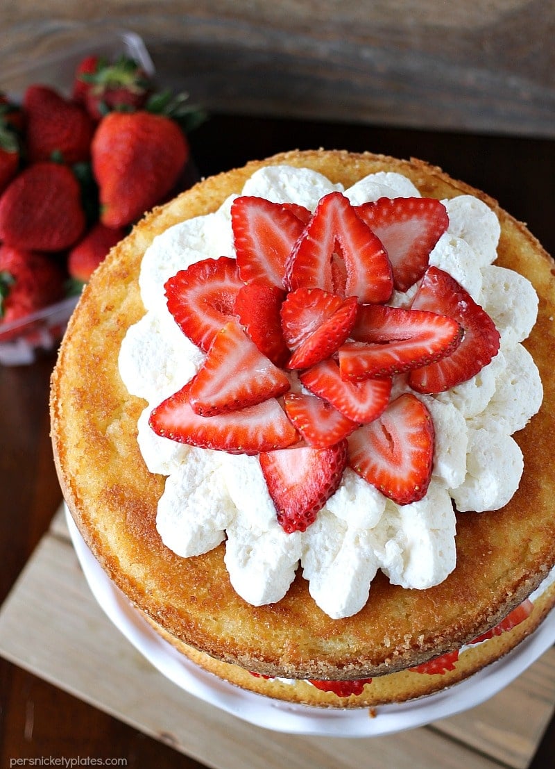 Strawberry Shortcake Cake is a rustic vanilla layer cake filled with a whipped cream cheese frosting and fresh strawberries. Easy, impressive, and SO good! | www.persnicketyplates.com