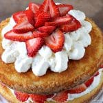 Strawberry Shortcake Cake is a rustic vanilla layer cake filled with a whipped cream cheese frosting and fresh strawberries. Easy, impressive, and SO good! | www.persnicketyplates.com