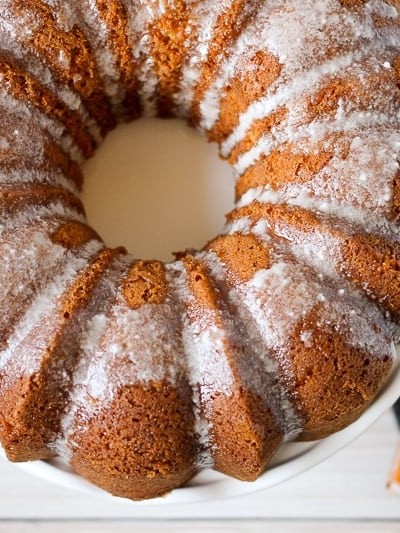 Overhead shot of butterscotch bundt cake on a cake plate with jello