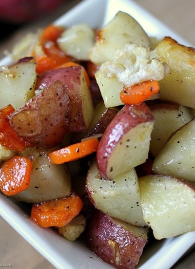Garlic Roasted Veggies are a mix of cauliflower, carrots, and red skin potatoes tossed in olive oil and garlic and roasted to perfection. | www.persnicketyplates.com