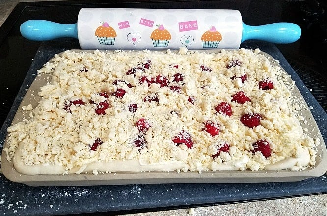 crumb topping on a raspberry crumb cake about to be baked.