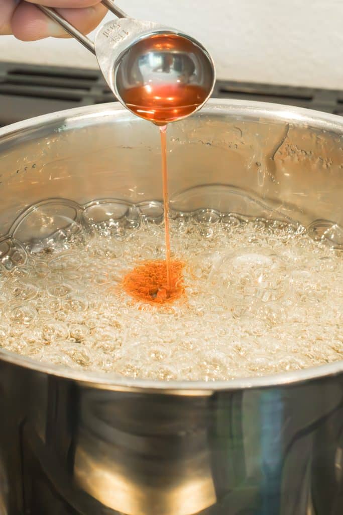 flavor oil pouring into a boiled saucepan.