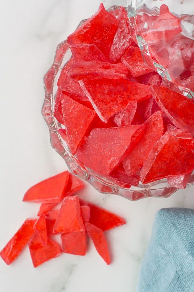 overhead shot of red hard candy in a glass dish.
